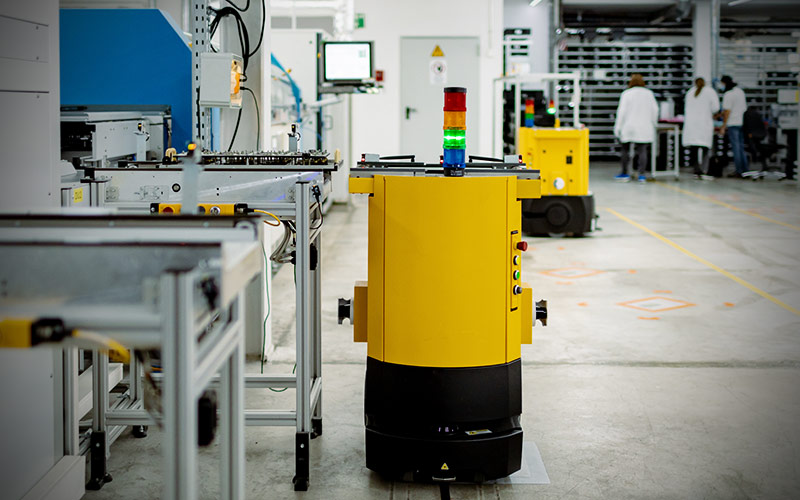 Automated Guided Vehicles (AGV) in front of wave soldering machine in our production